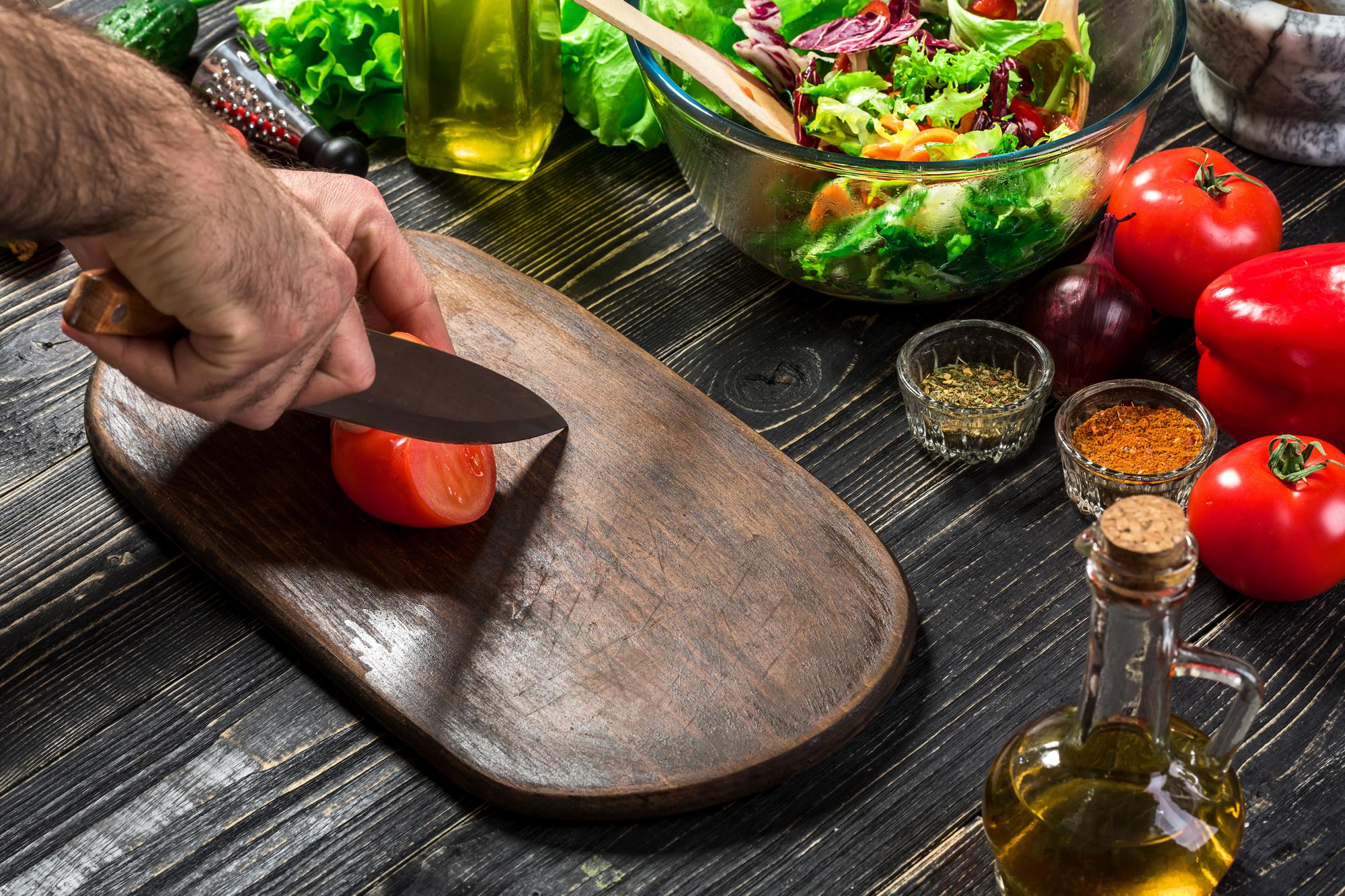 Chef preparing ingredients on a wooden board